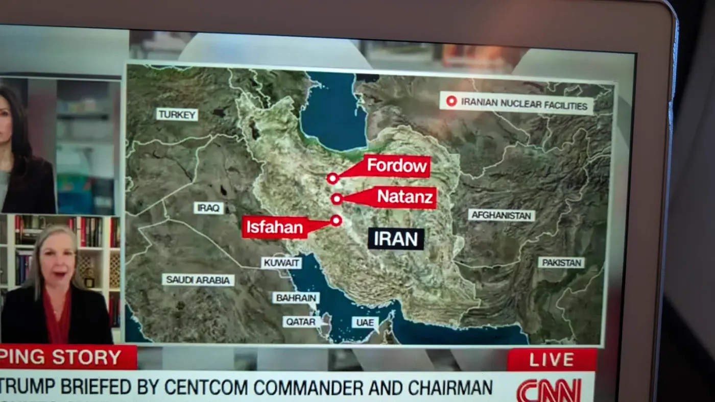 Live CNN on seatback screen: Trump Briefed by CENTCOM Commander with map of Iranian Nuclear Facilities including Fordow, Natanz, and Isfahan