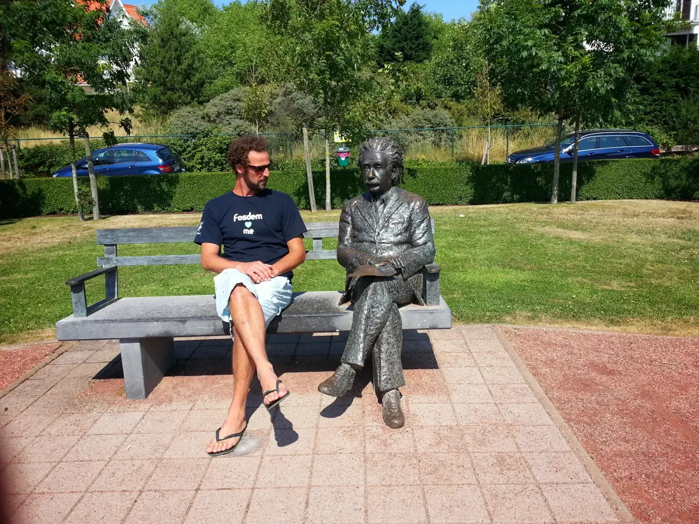 Jérôme assis à côté d'Einstein avec son T-shirt FOSDEM