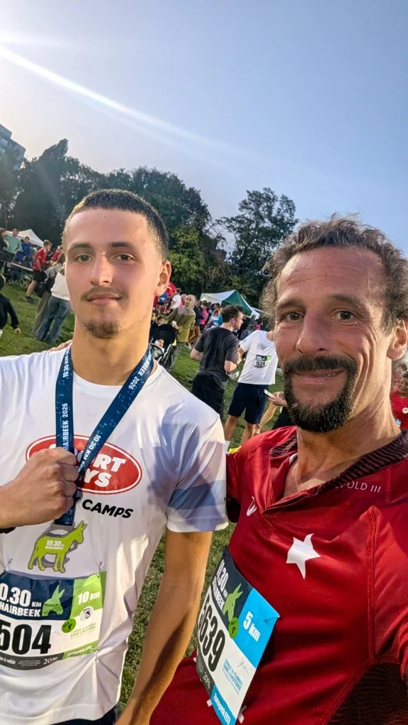 Arthur (bib #504 with finisher medal) and Jerome CG Paquay (bib #5639 in red Royal White Star HC jersey) after the 10,30 km de Schaerbeek 2026 run